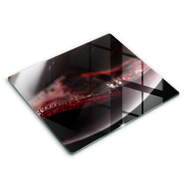 Tábua de corte de vidro Um copo de vinho tinto