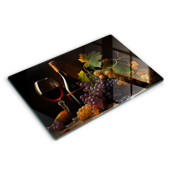Tábua de cortar de vidro Um copo de vinho e uvas