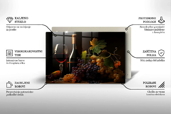 Tábua de cortar de vidro Um copo de vinho e uvas