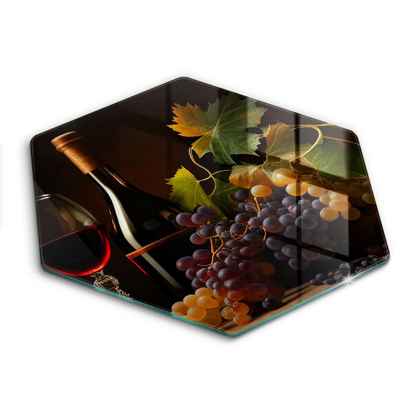 Tábua de corte de vidro Um copo de vinho e uvas
