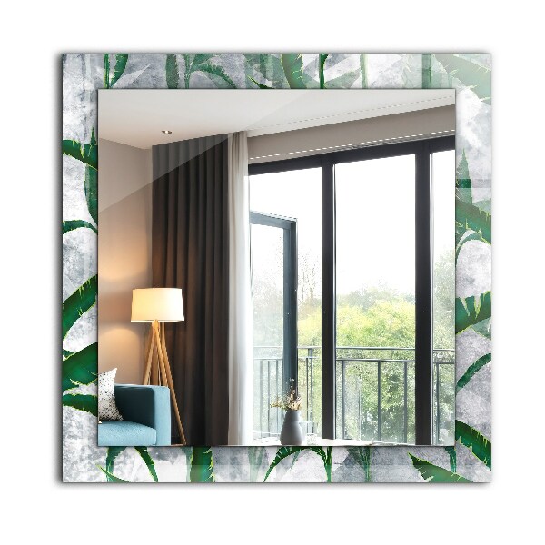 Espelho com moldura decorada de plantas com folhas verdes